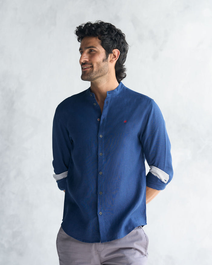 Person wearing a navy Nawab shirt with a band collar.