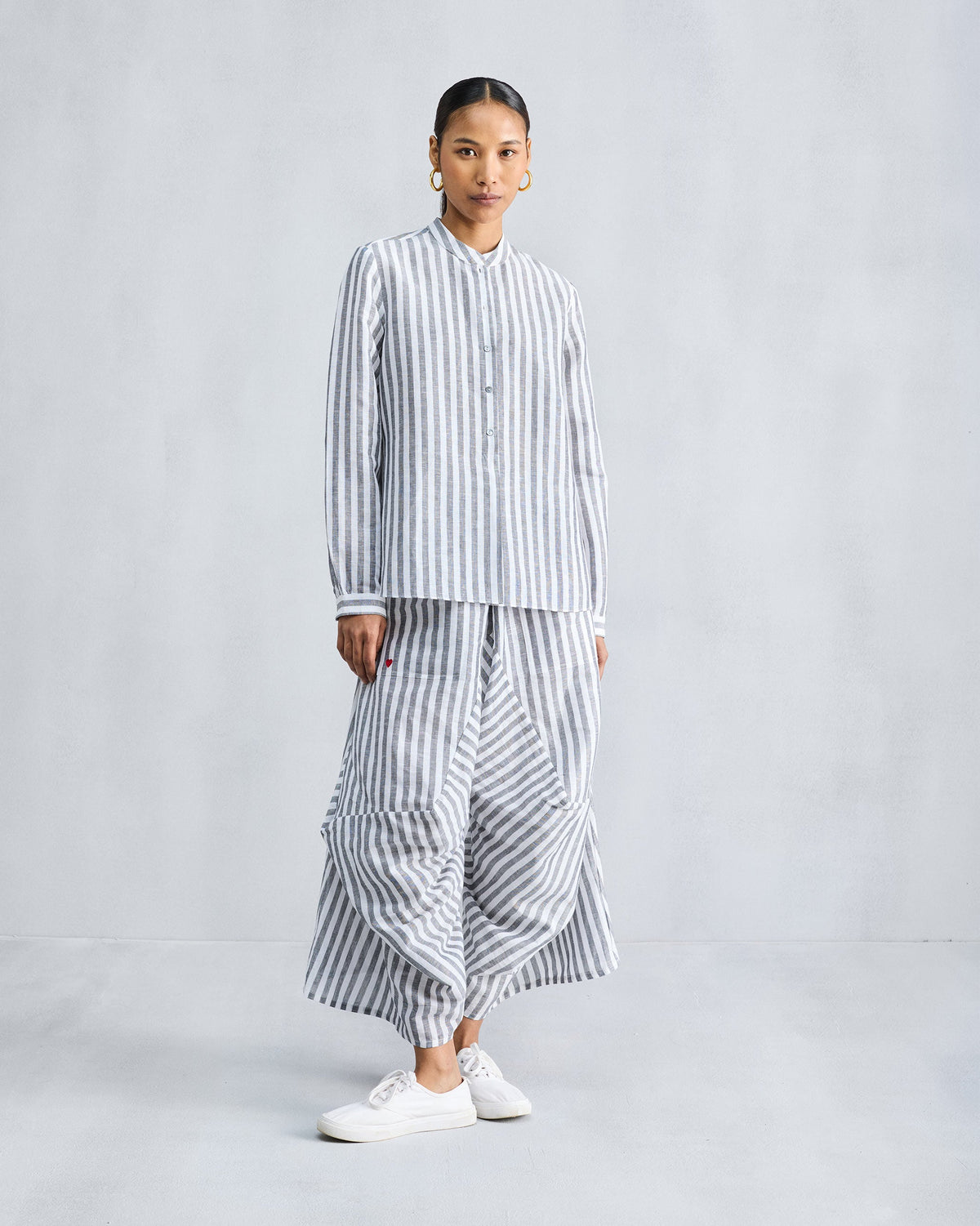 Charcoal and white striped Yoka Trousers worn with a matching shirt.