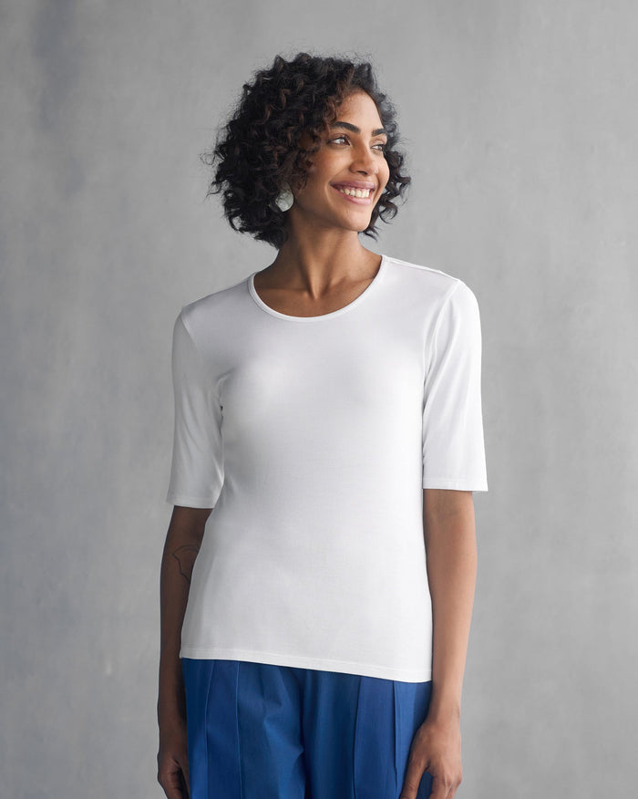 Person wearing a white Luna Jersey Top with elbow-length sleeves.