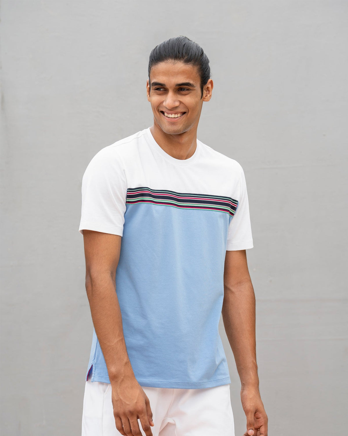Person wearing an Everyday Crew Neck T-shirt in white and blue with a striped chest band.