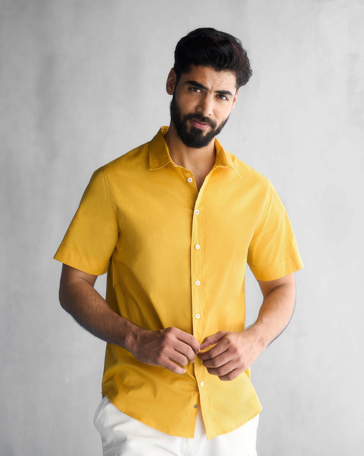 Person wearing an ochre Half Sleeve Shirt with a plain front.