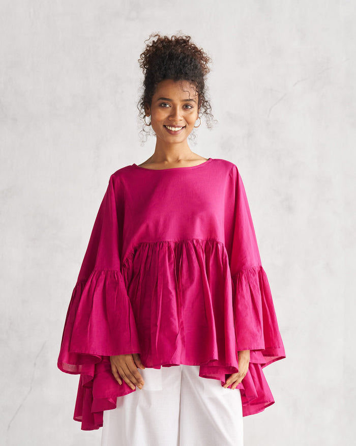 Person wearing a berry Frill Top with tiered flared sleeves.