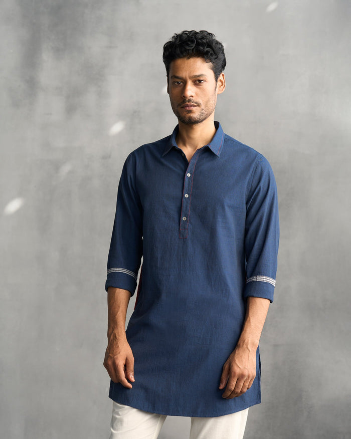 Person wearing a navy Kantha Stitch Kurta with stitched cuff trim.