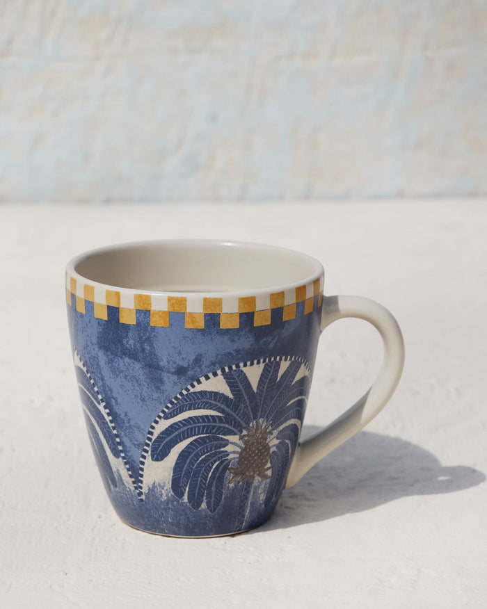 Caravan Mug with a blue palm motif and a mustard checked rim.