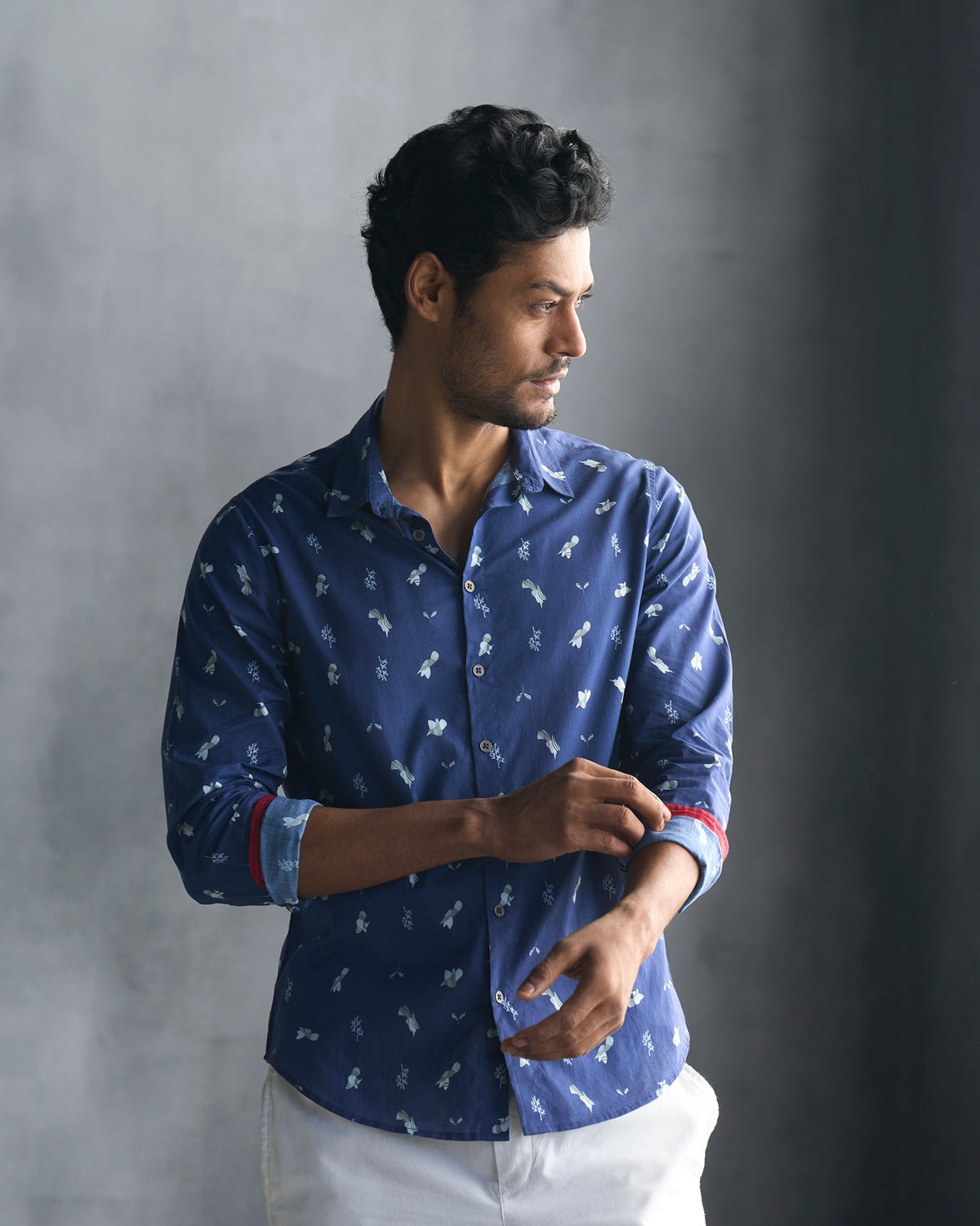 Person wearing a navy Hakuna Shirt with a small white print.