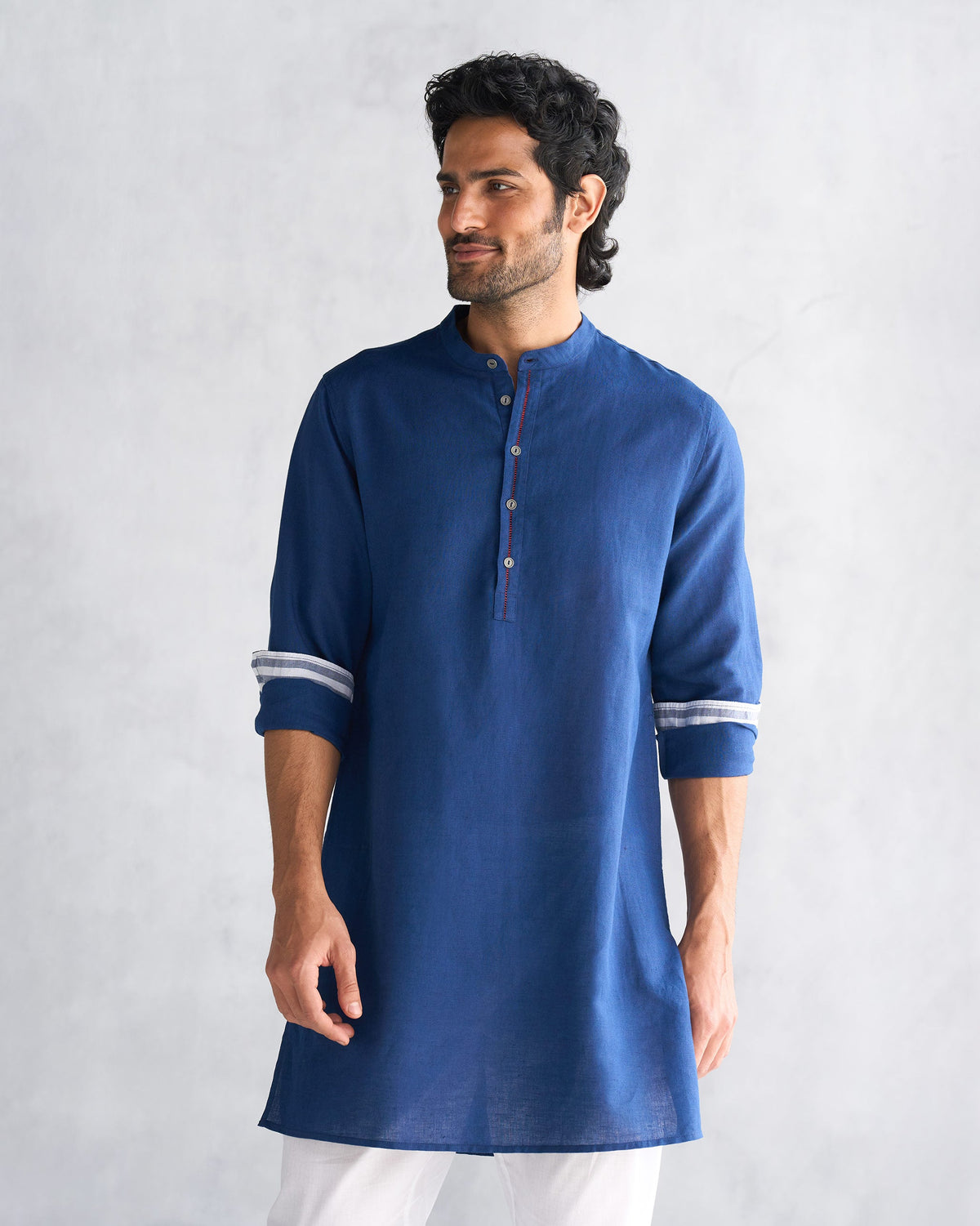 Person wearing a navy Chandni Chowk kurta with a Nehru collar.