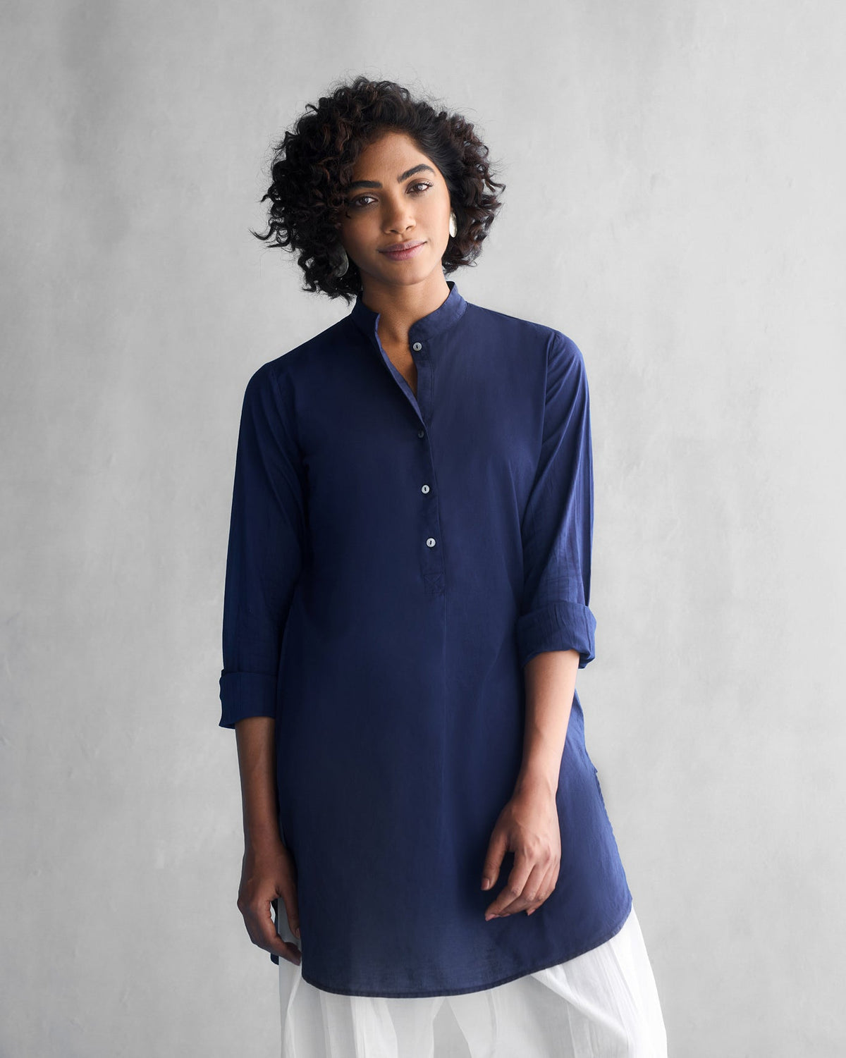 Person wearing a blue Basic Mid Length Kurta with a band collar.