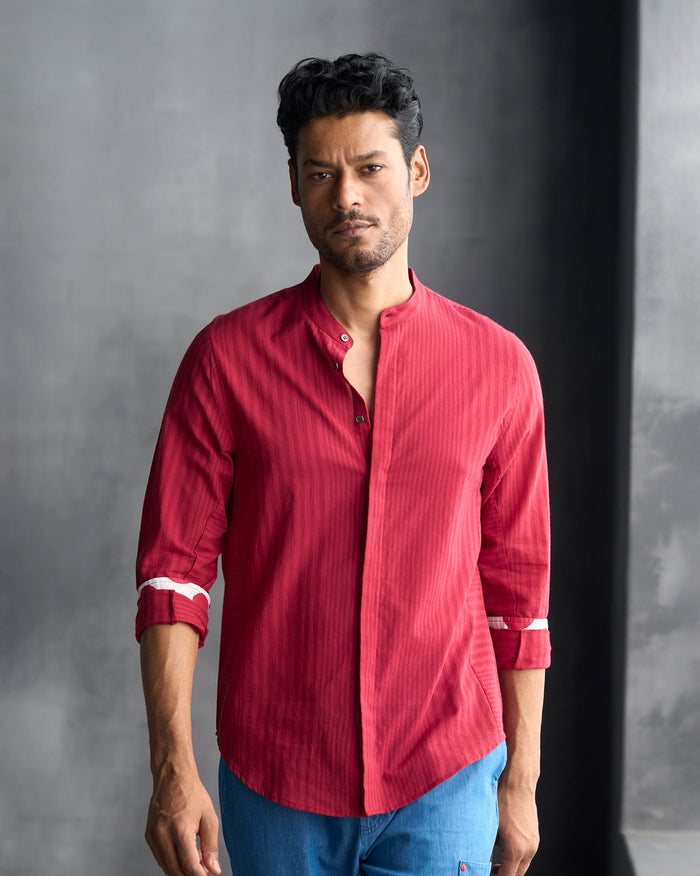 Person wearing a red Side Panel shirt with a band collar.