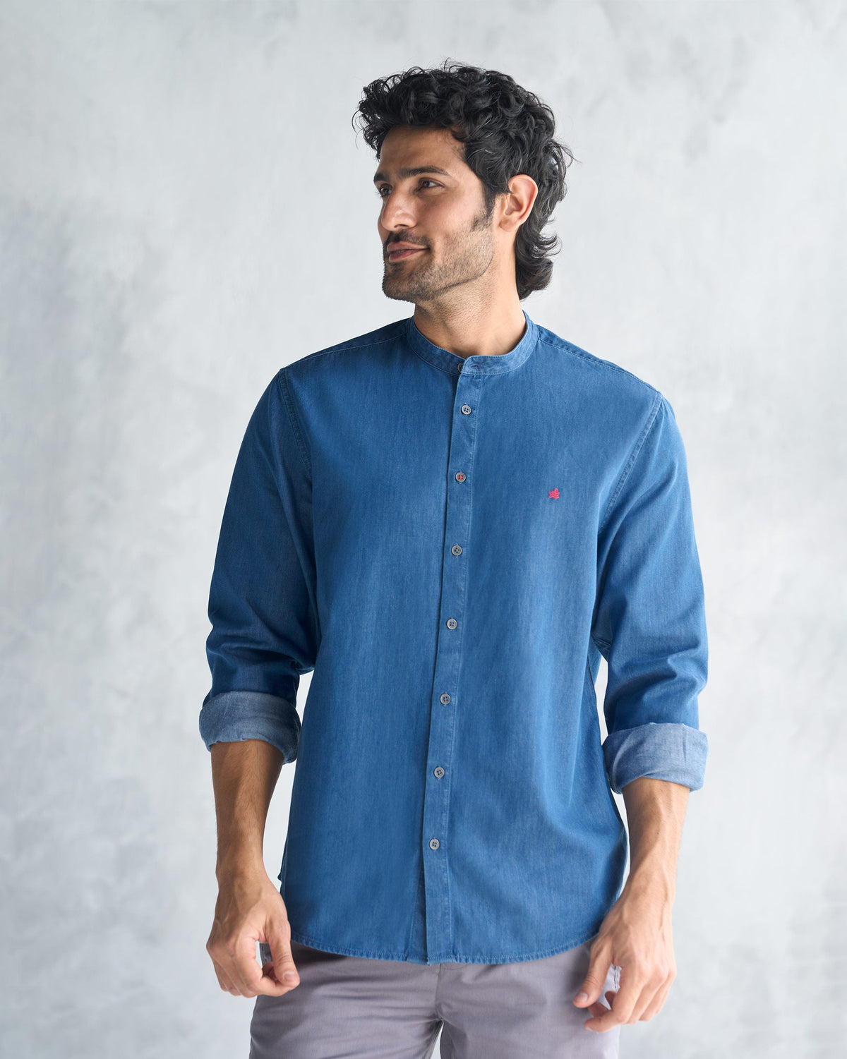 Person wearing a blue Nawab Shirt with a band collar and red chest mark.