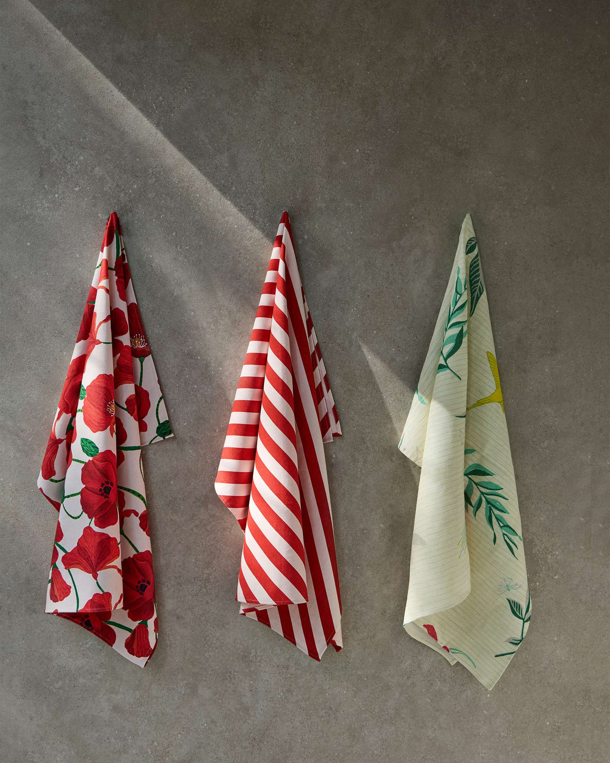 Red Candy Stripe towel hanging beside two other prints.