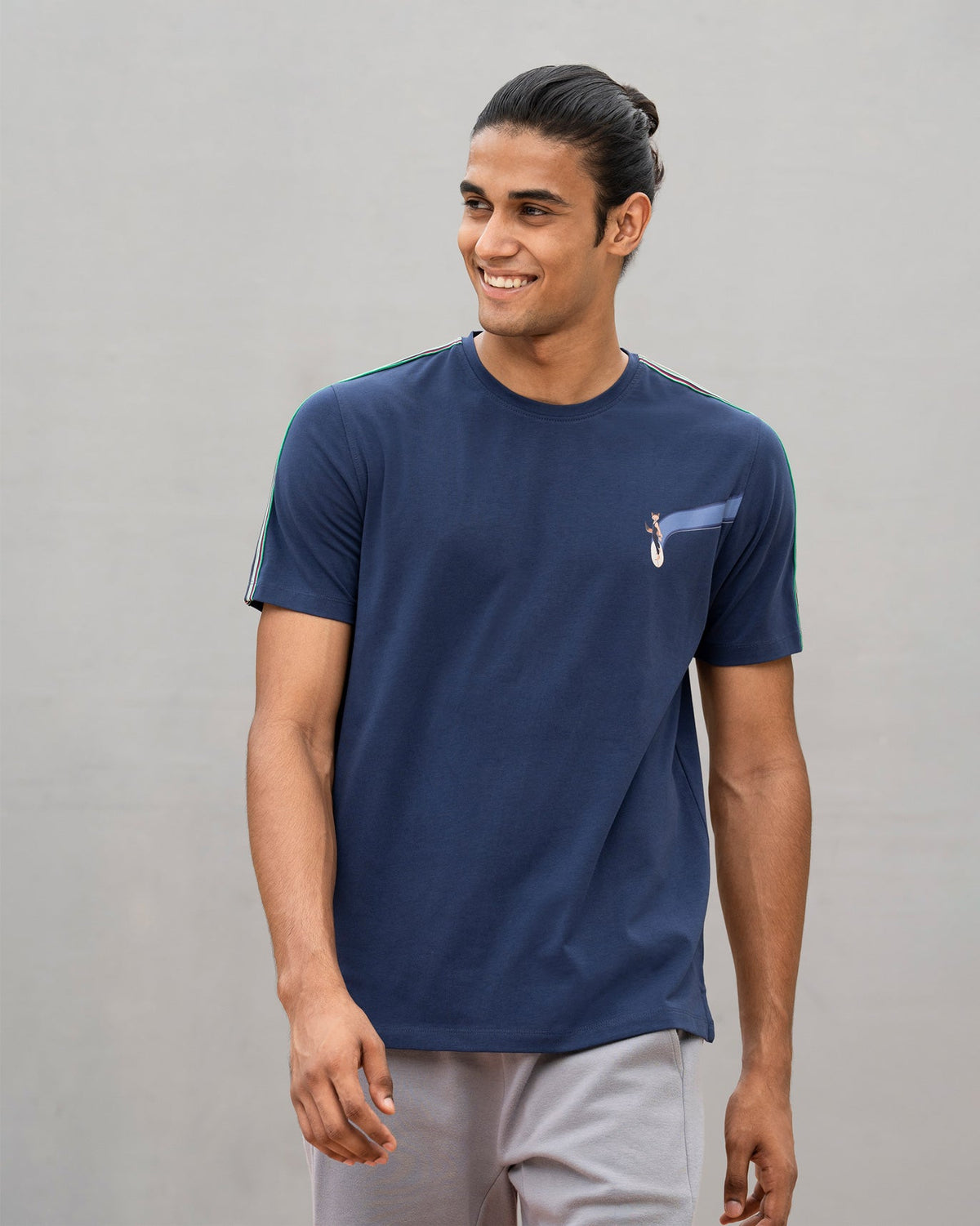 Person wearing a navy Nico crew neck t-shirt with a small fox graphic on the chest.
