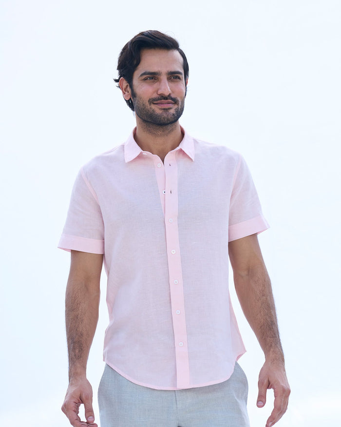 Person wearing a pink Slim Half Sleeve Shirt with short sleeves.