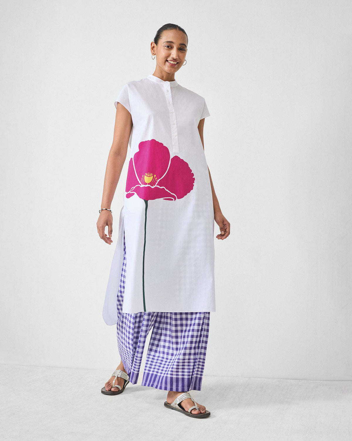 Person wearing purple and white checked Wide Paper Bag Trousers with wide legs.