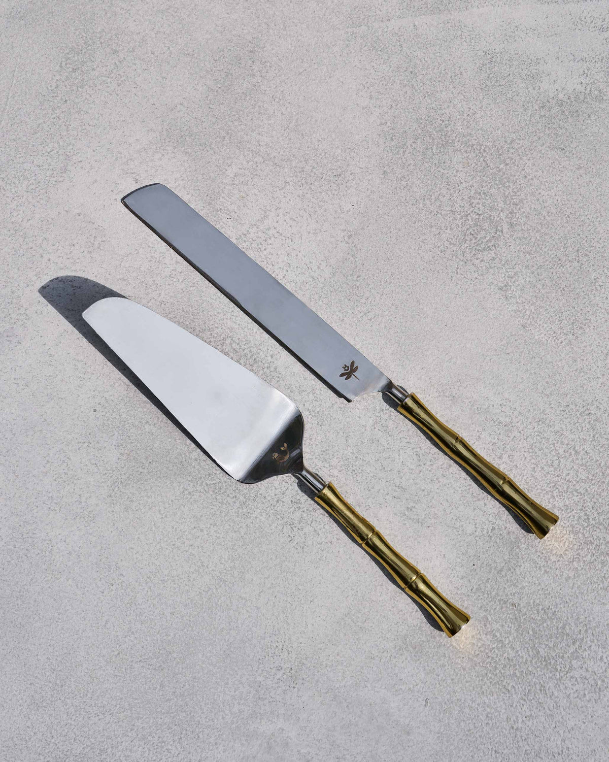 Sunrise cake knife and server with gold bamboo handles.