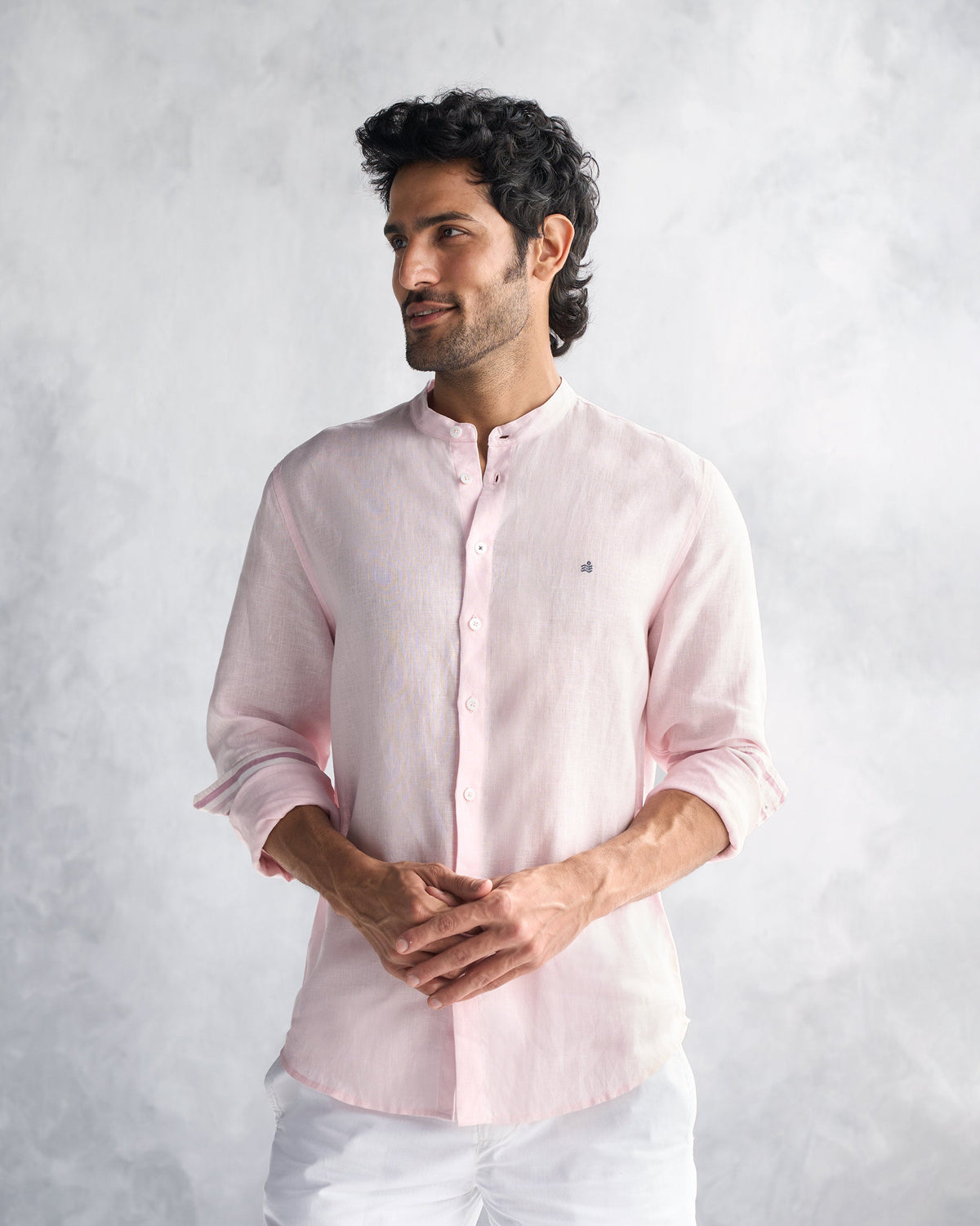 Person wearing a pink Nawab Shirt with a band collar and rolled sleeves.