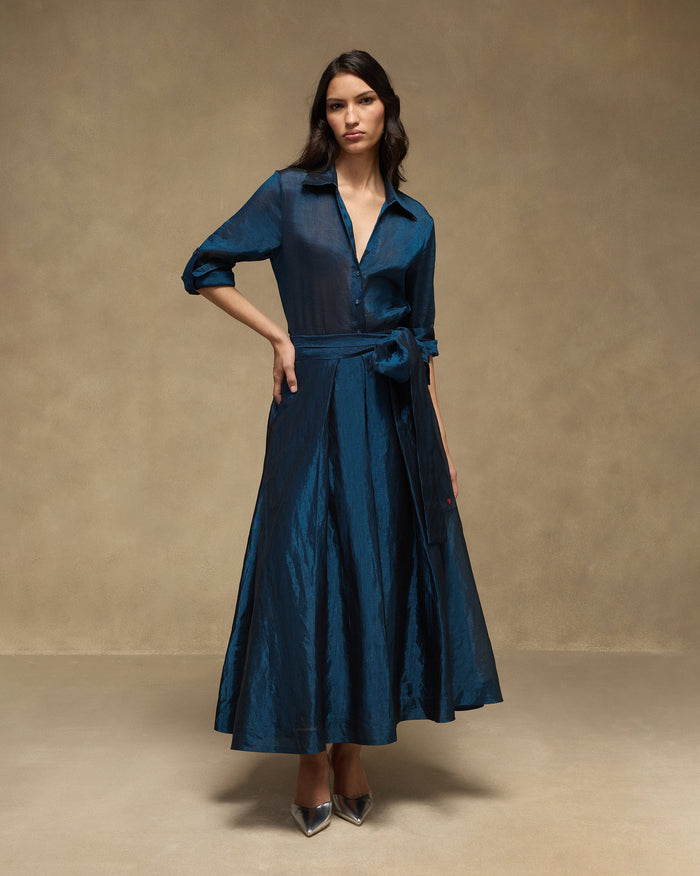 Person wearing a sapphire blue Swing Shirt Set with a sash belt and A-line skirt.