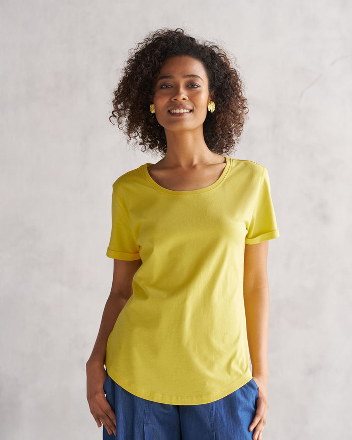 Person wearing a yellow Basic T-Shirt.