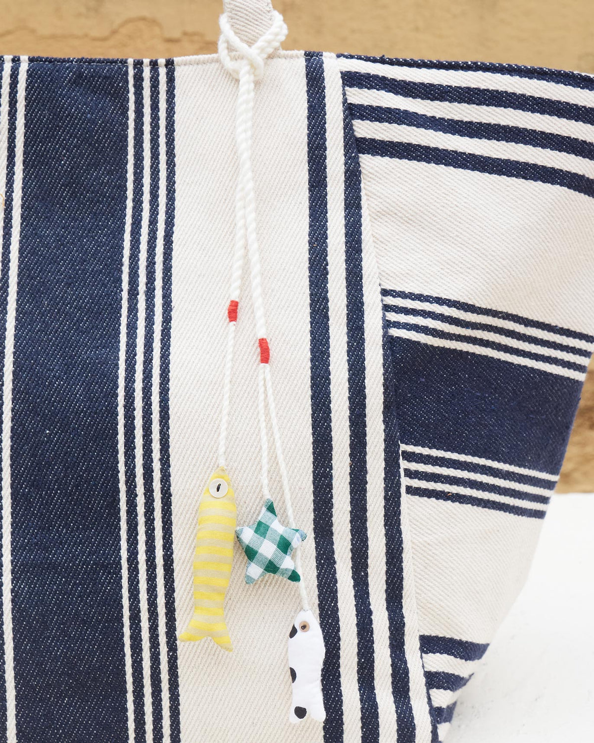 Close-up of the Serenity Tote side showing its navy and ivory stripes.