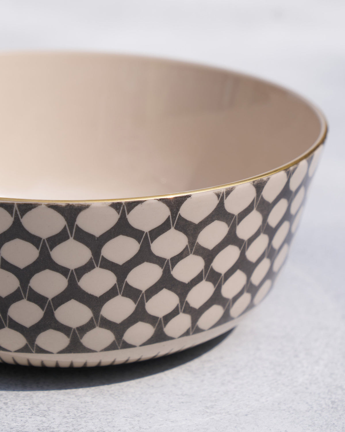 Close-up of a Fez curry bowl showing the gold rim and teardrop print.