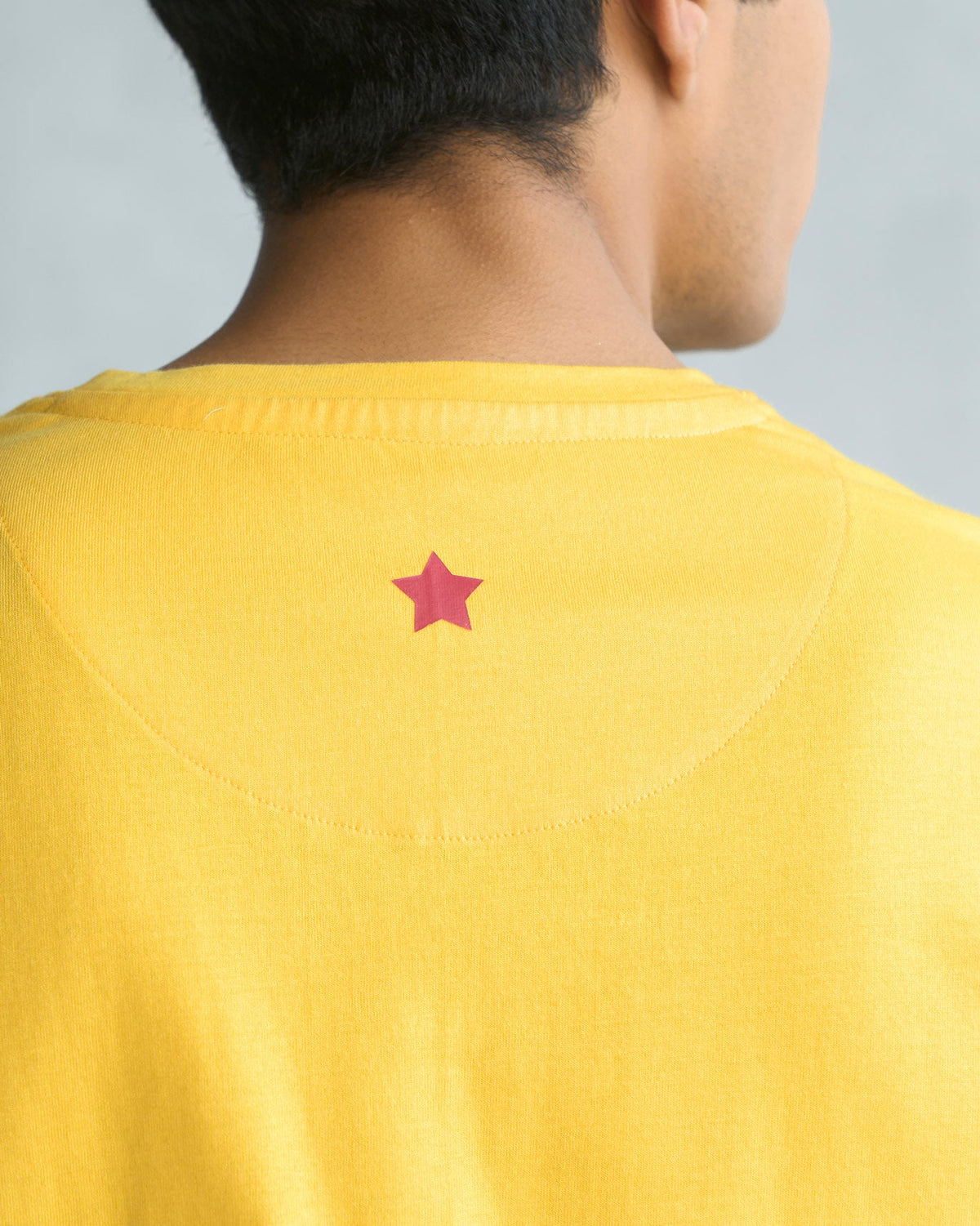 Close-up of the Toucan T-shirt's back showing a small pink star embroidery.