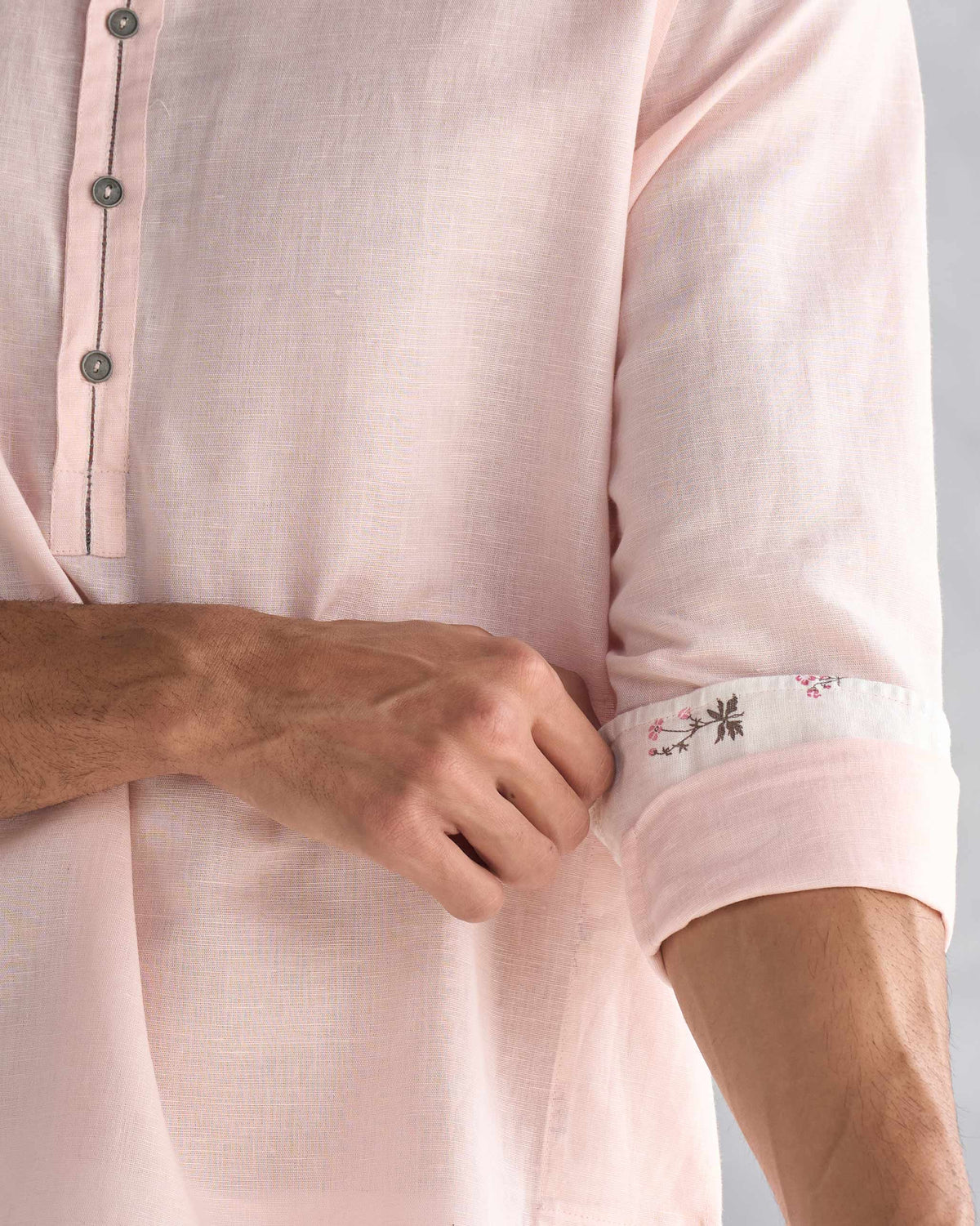 Close-up of the floral cuff lining on a pink Chandni Chowk kurta.