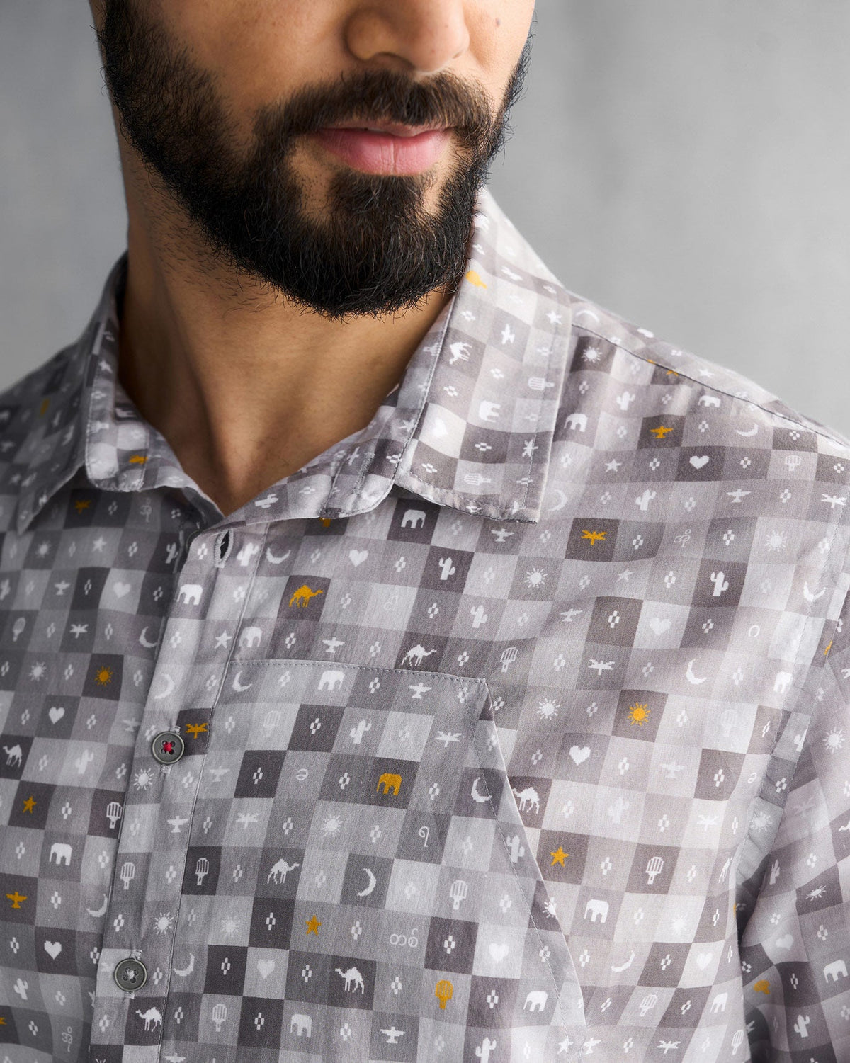 Close-up of a grey Pocket Shirt collar and placket with small animal and star prints.