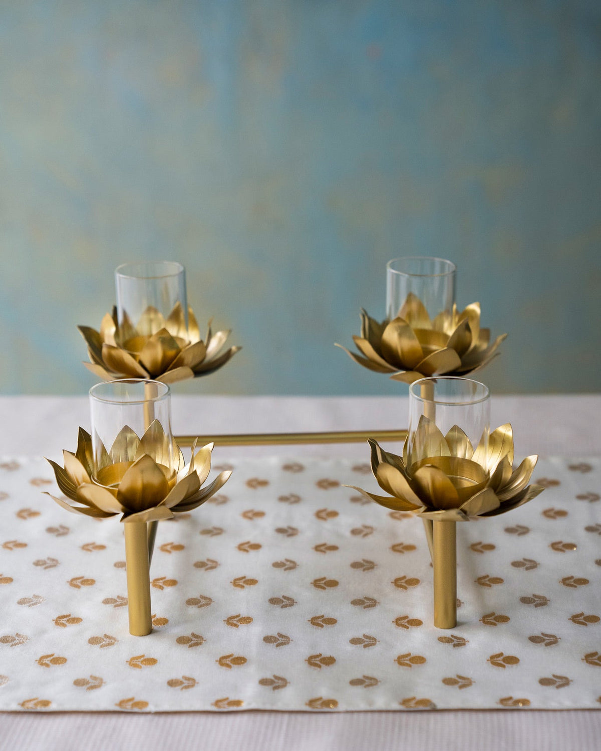 Sitara tealight stand seen from the front, with four gold lotus holders.