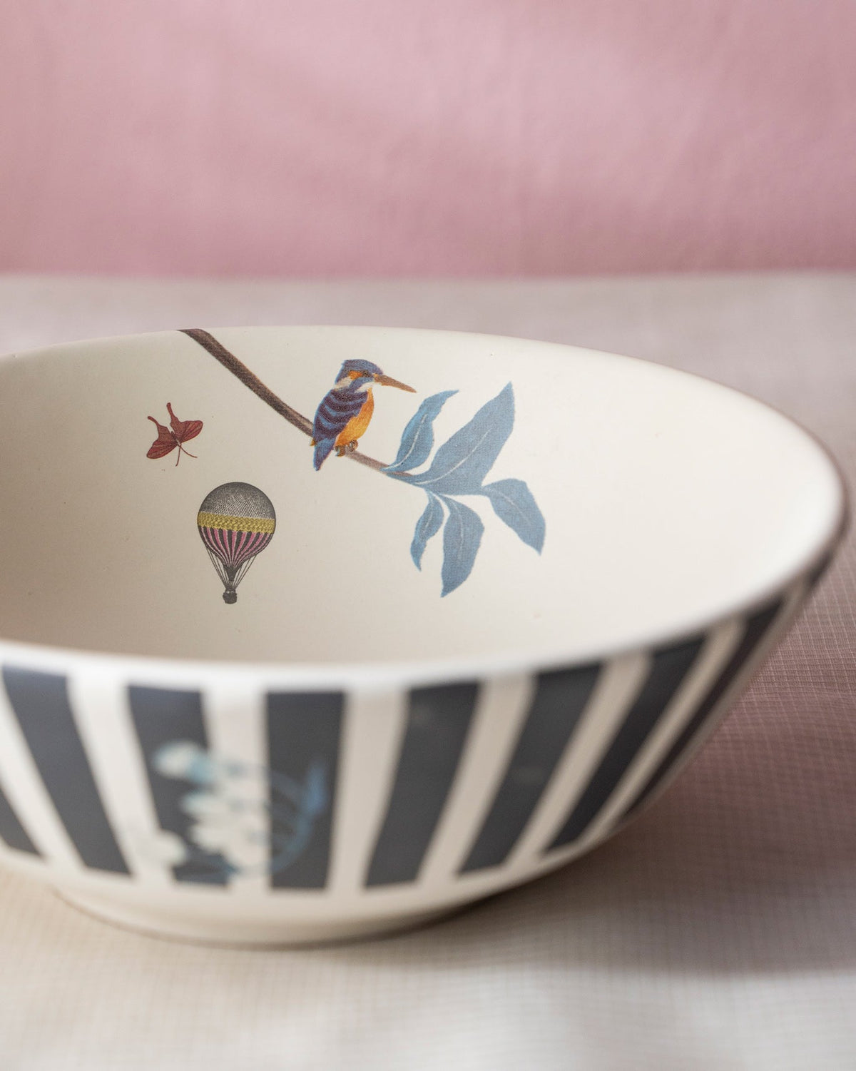 Close-up of a Myra curry bowl showing a kingfisher and hot-air balloon.