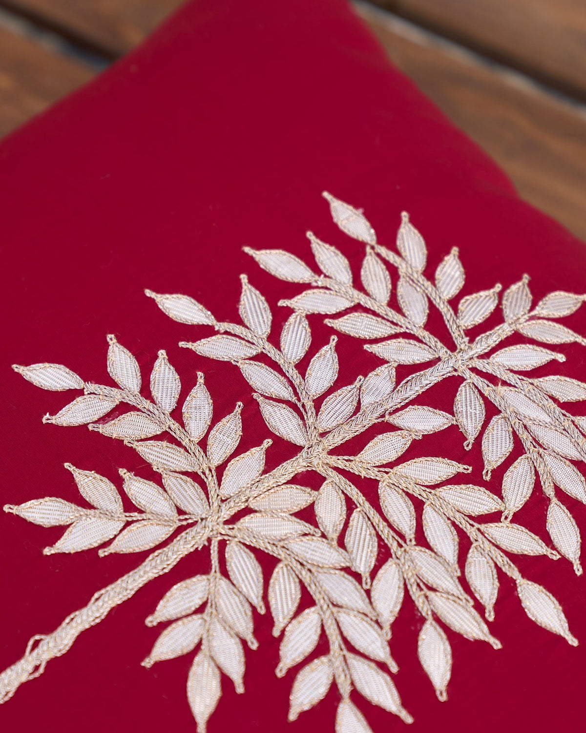 Close-up of Golden Palm Cushion Cover showing the embroidered leaves.
