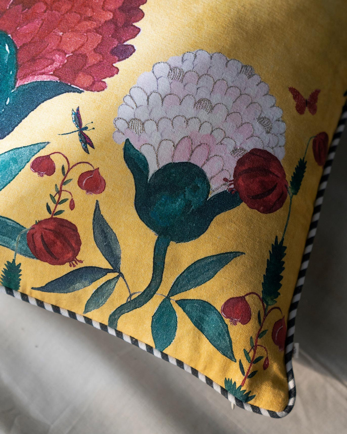 Close-up of Winter Wonderland Cushion Cover showing its piped edge and printed flowers.
