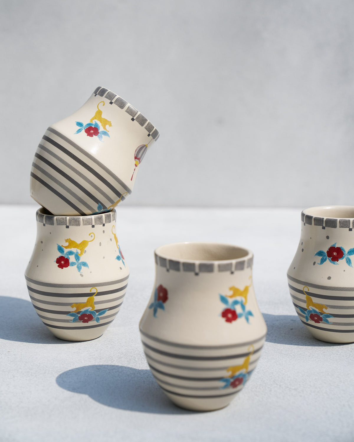 Two Phoenix kulhar cups stacked, showing grey stripes and a checked rim.