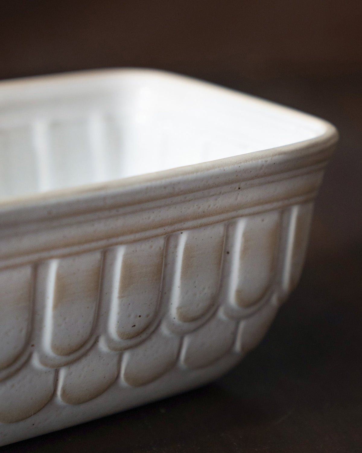 Close-up of the Dawn Loaf Pan showing its scalloped side and glazed rim.