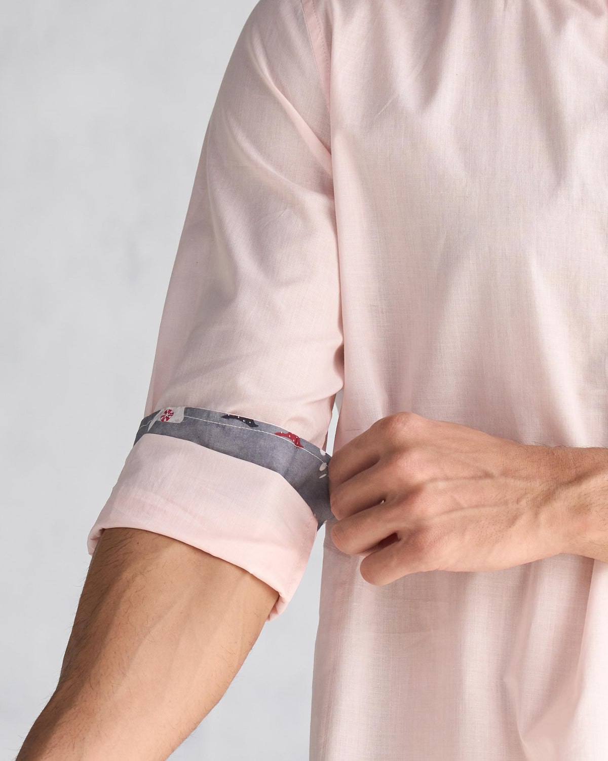 Close-up of a pink Pondicherry kurta sleeve showing the printed cuff lining.
