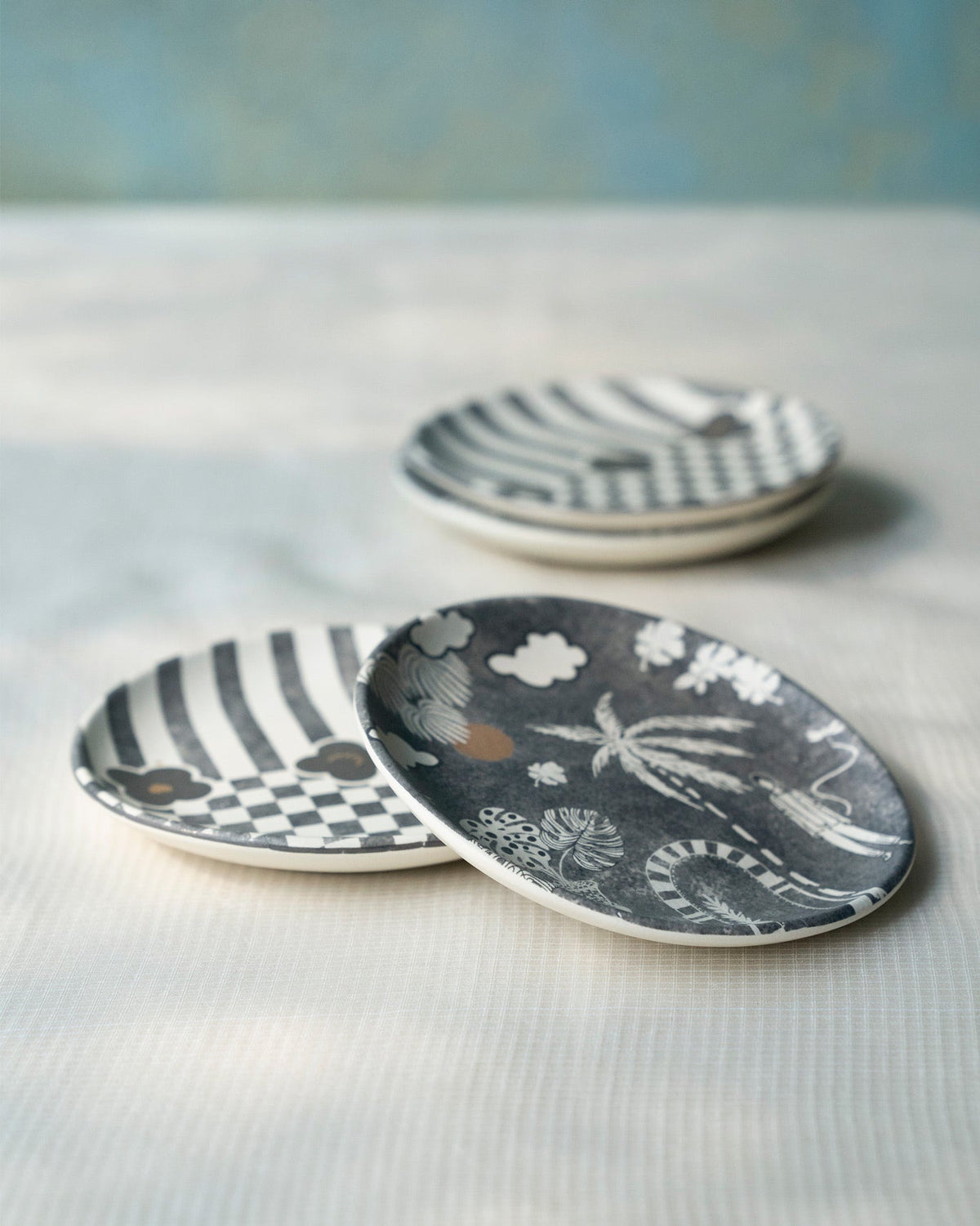 Mandovi Tea Plates stacked at an angle, with stripe, check and palm prints.