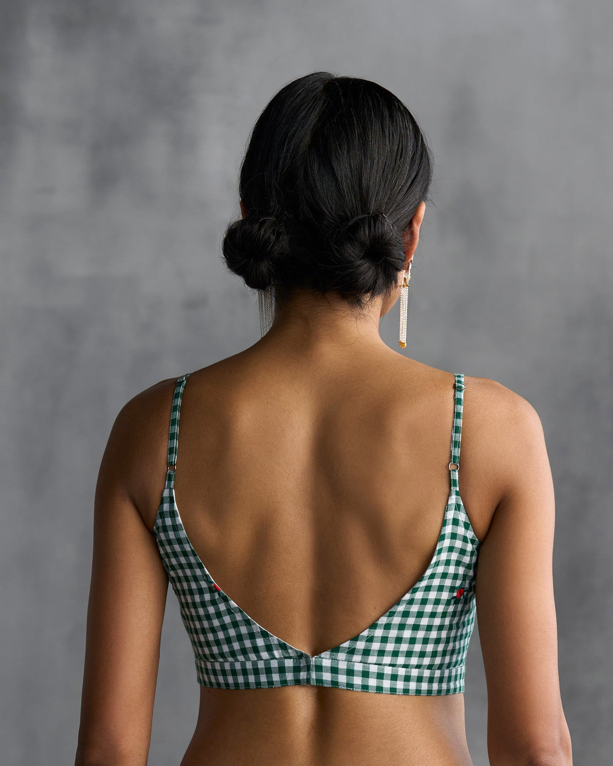 Back of green gingham Strappy Blouse worn by a person, with a V-shaped open back.