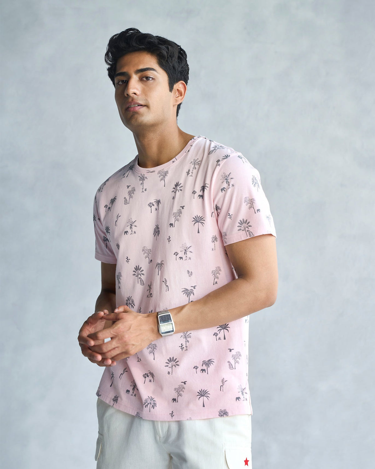 Side view of a soft pink Jungle T-shirt worn by a person.