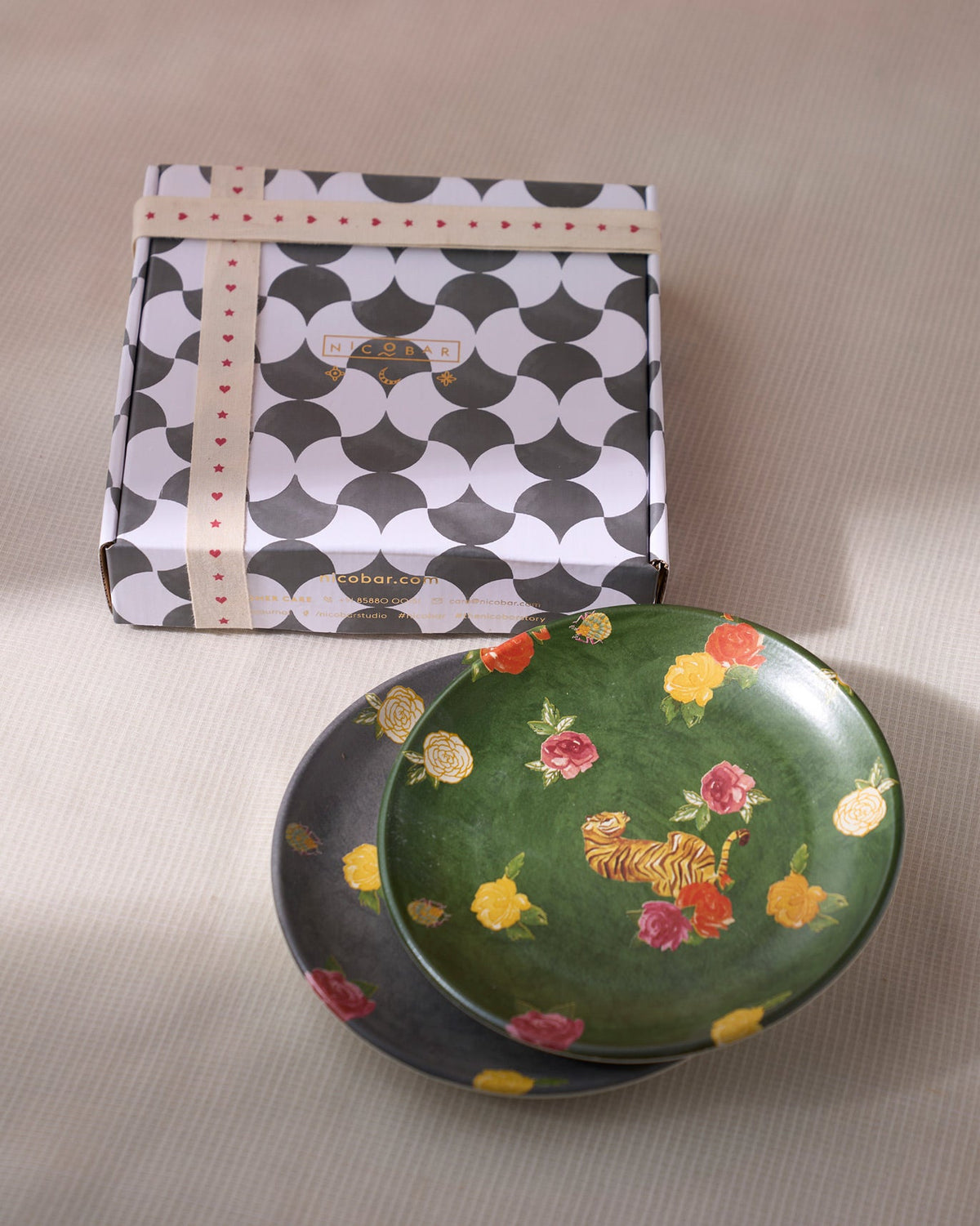 Stacked Tigress Quarter Plates in green and grey with tiger motifs.
