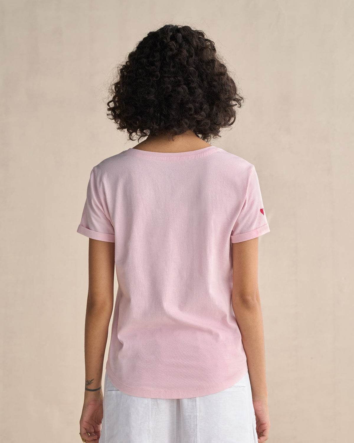 Back of pink Basic T-Shirt worn by a person.