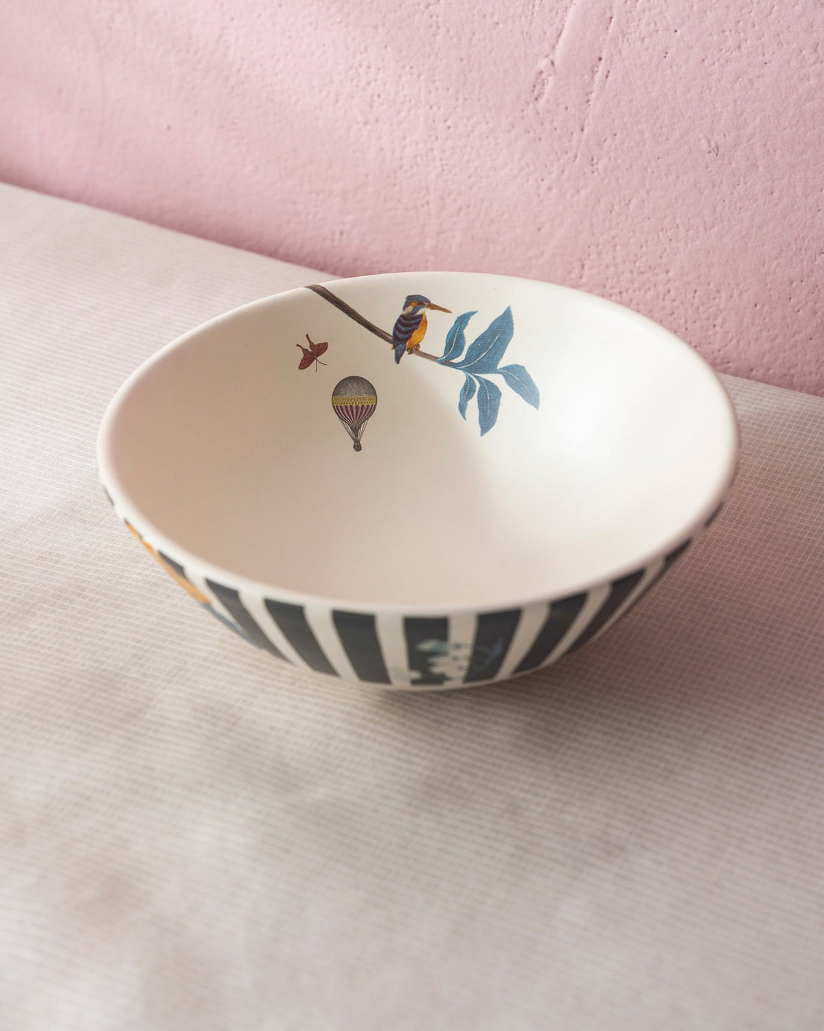 Myra curry bowl with striped exterior and kingfisher motif inside.