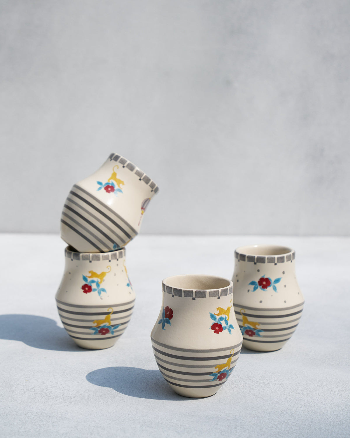Phoenix kulhar cups grouped together, one tipped on its side.