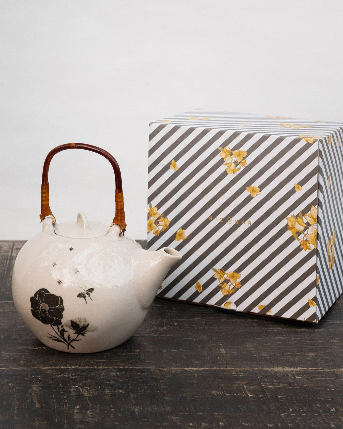 Poppy teapot standing next to its grey striped Nicobar gift box.
