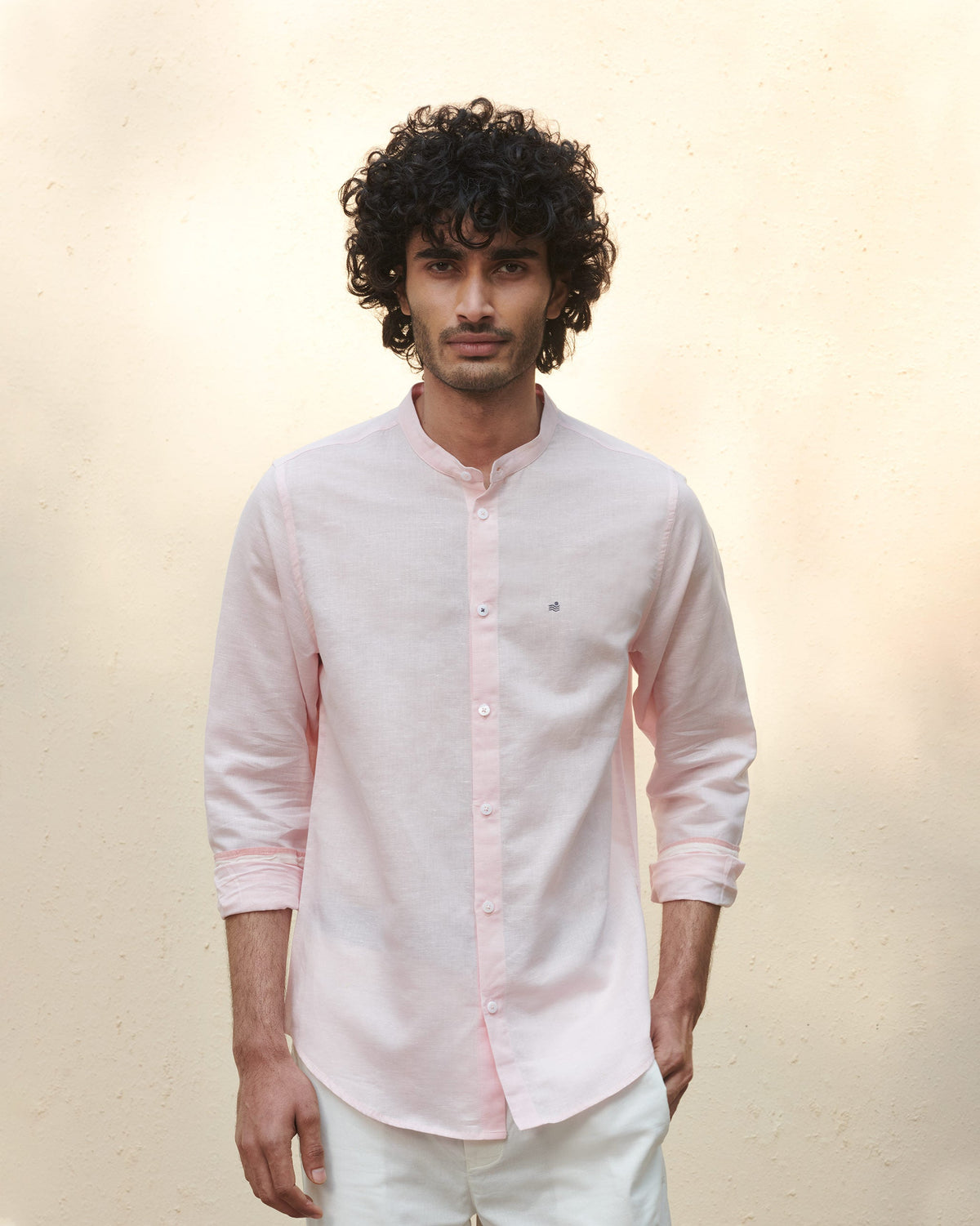 Person wearing a pink Nawab shirt with a band collar.