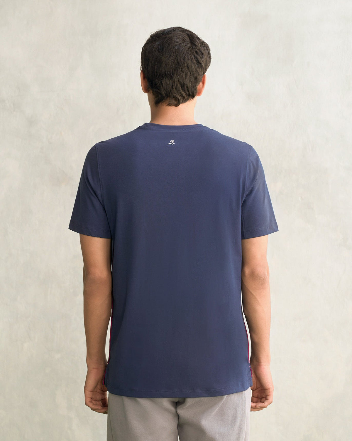 Back of a navy Club Crew Neck T-shirt worn by a person.
