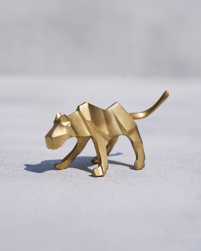 Side view of a gold leopard origami figure.