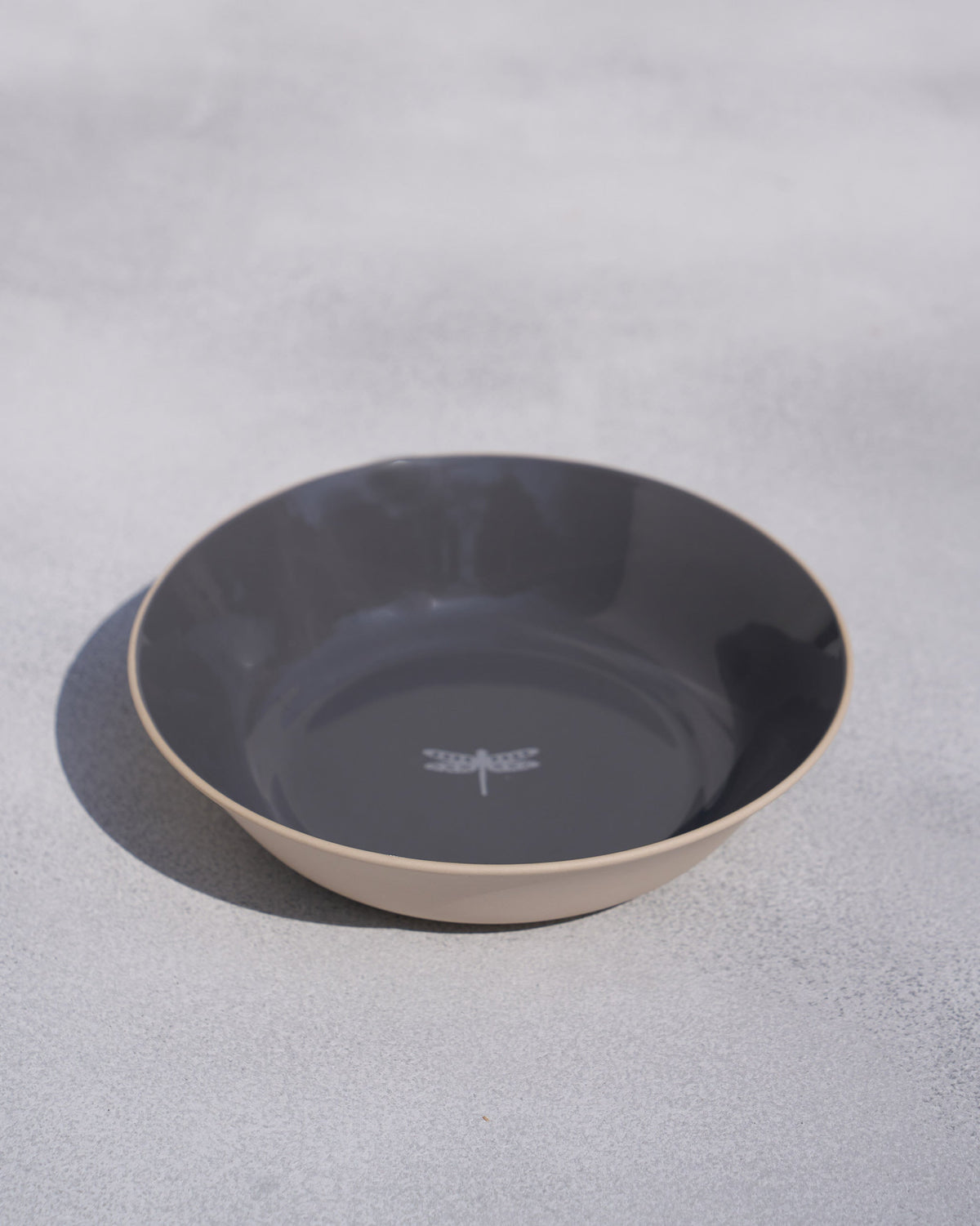 Kangra Vegetable Bowl with a grey interior, tan rim and dragonfly motif on the base.