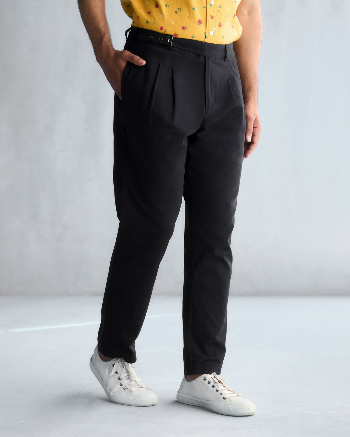 Three-quarter view of black Trunk & Twill trousers worn by a person.