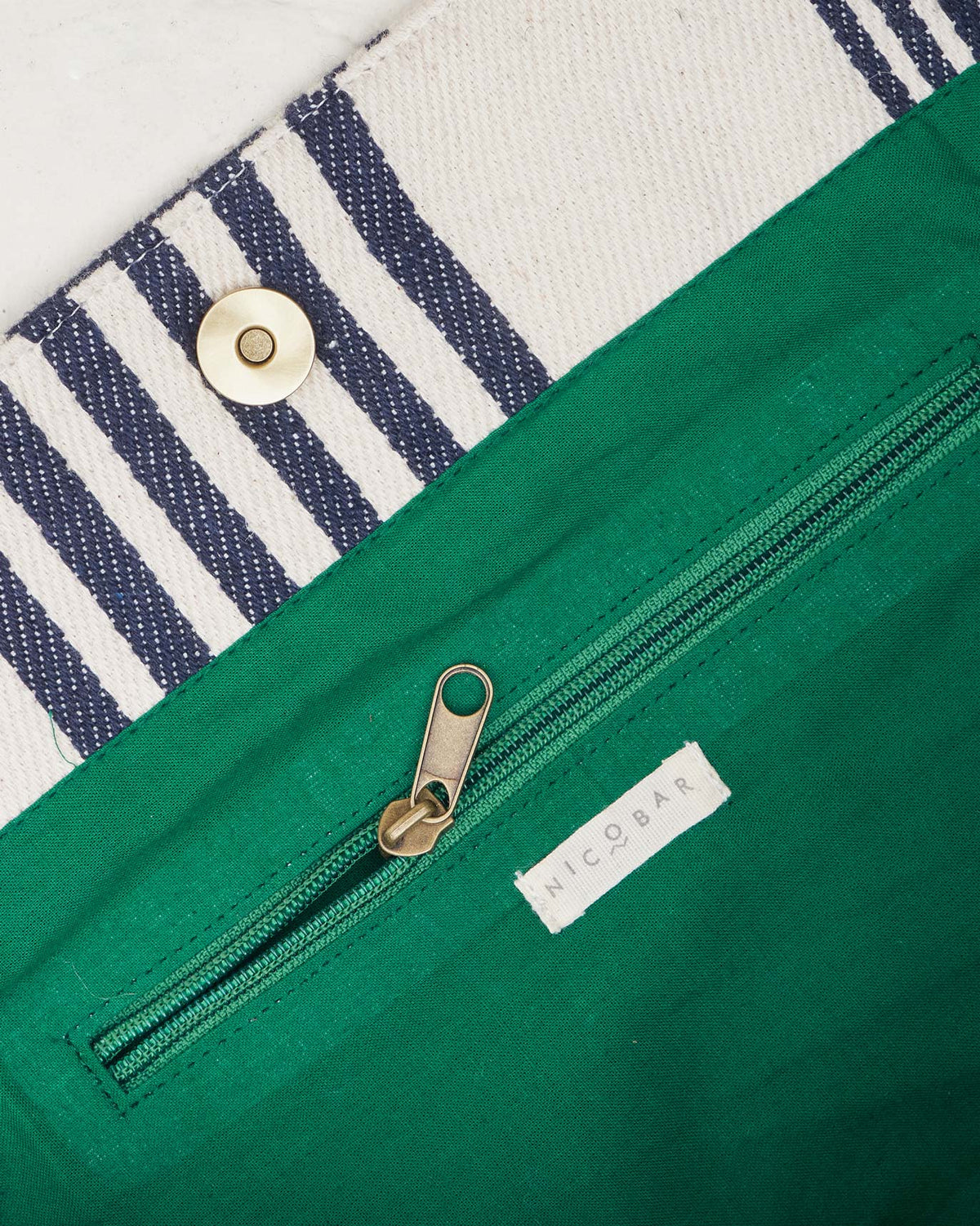 Inside of the Serenity Tote showing its green lining and zip pocket.
