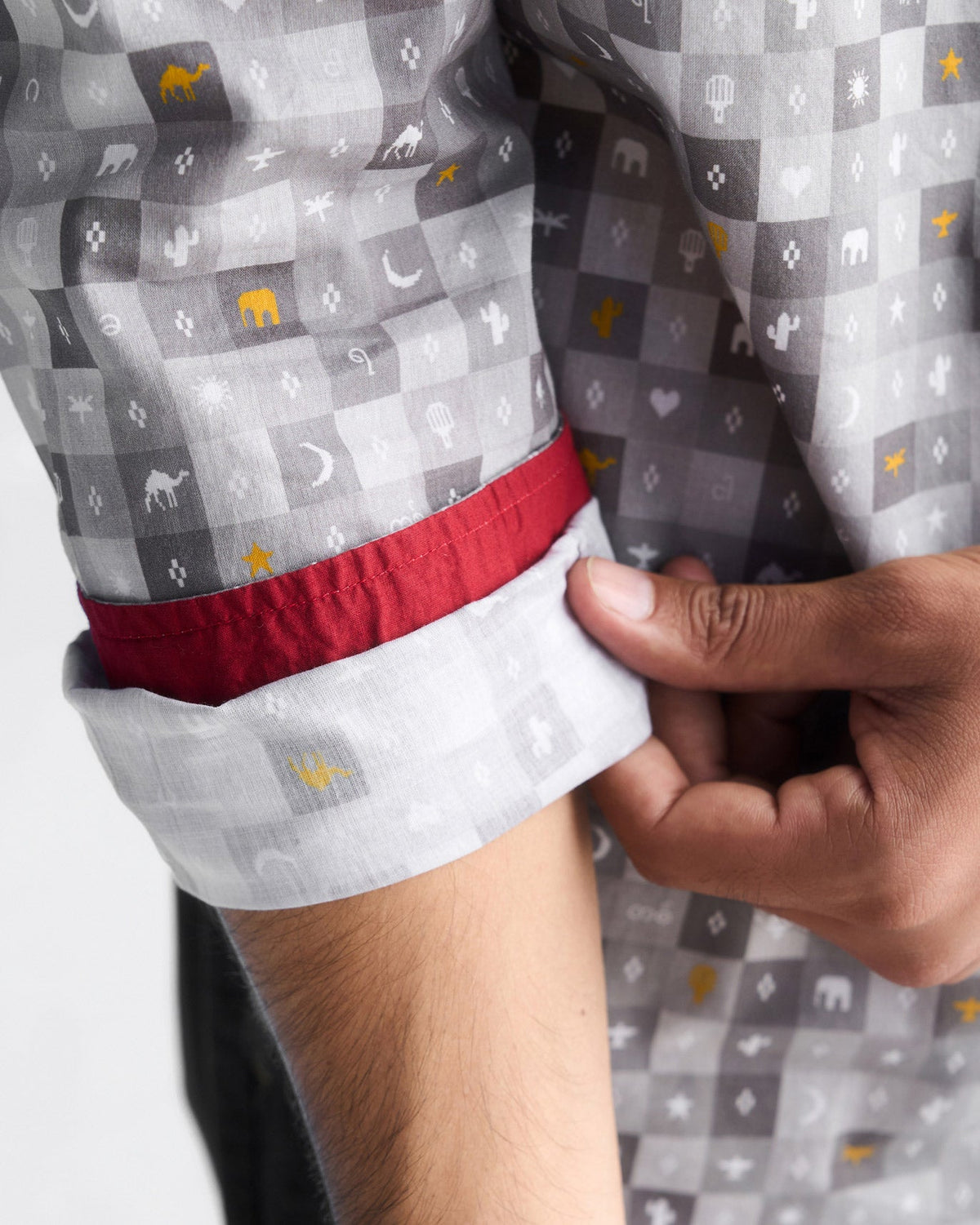 Close-up of a grey Pocket Shirt sleeve cuff with a red lining and tile print.