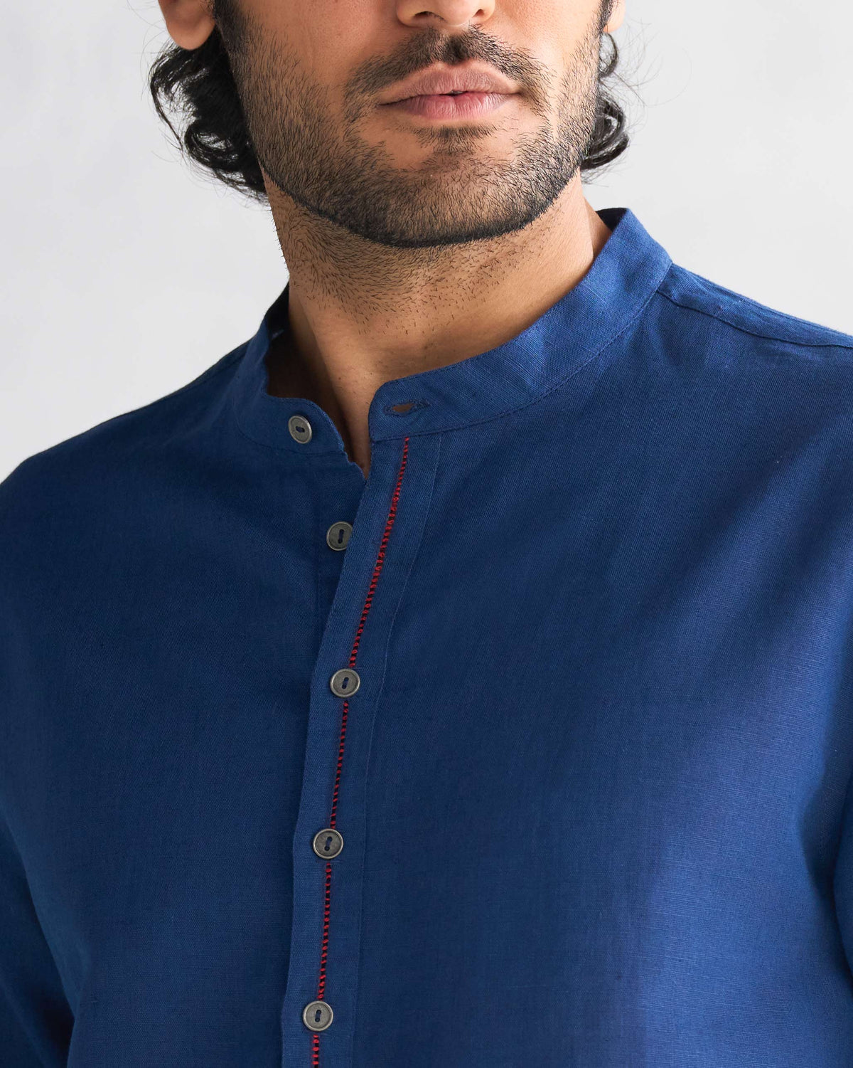Close-up of the Nehru collar and placket on a navy Chandni Chowk kurta.