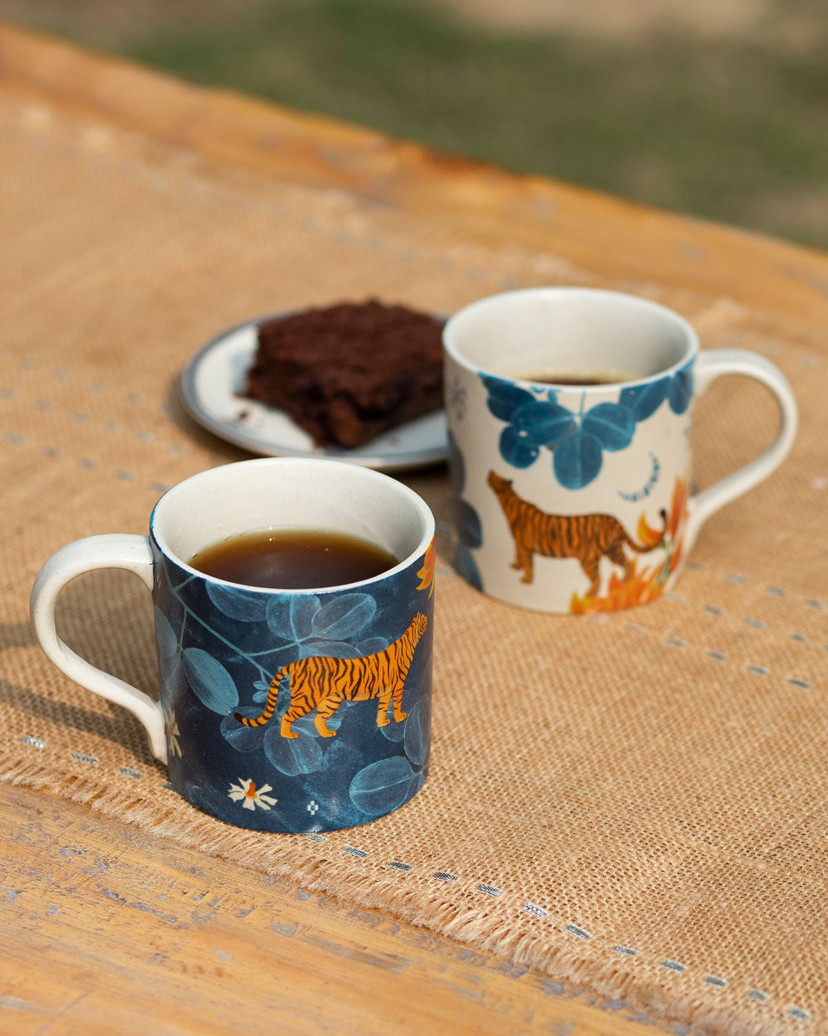 Navy and cream Nadi straight mugs with orange tiger and blue leaf prints.